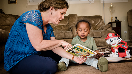 Natalie-ECI-staff reading to child
