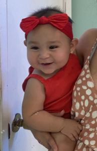 Baby girl in red dress and bow